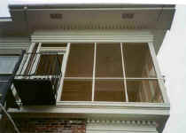 The Second floor porch with copper screen. The spiral staircase makes access to the second floor where double doors can remain open on cool days. There is also another door leading into a guest room. 