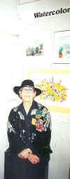 Lillian posing underneath her painting at the "Old Firehouse Gallery", reception in 2001
